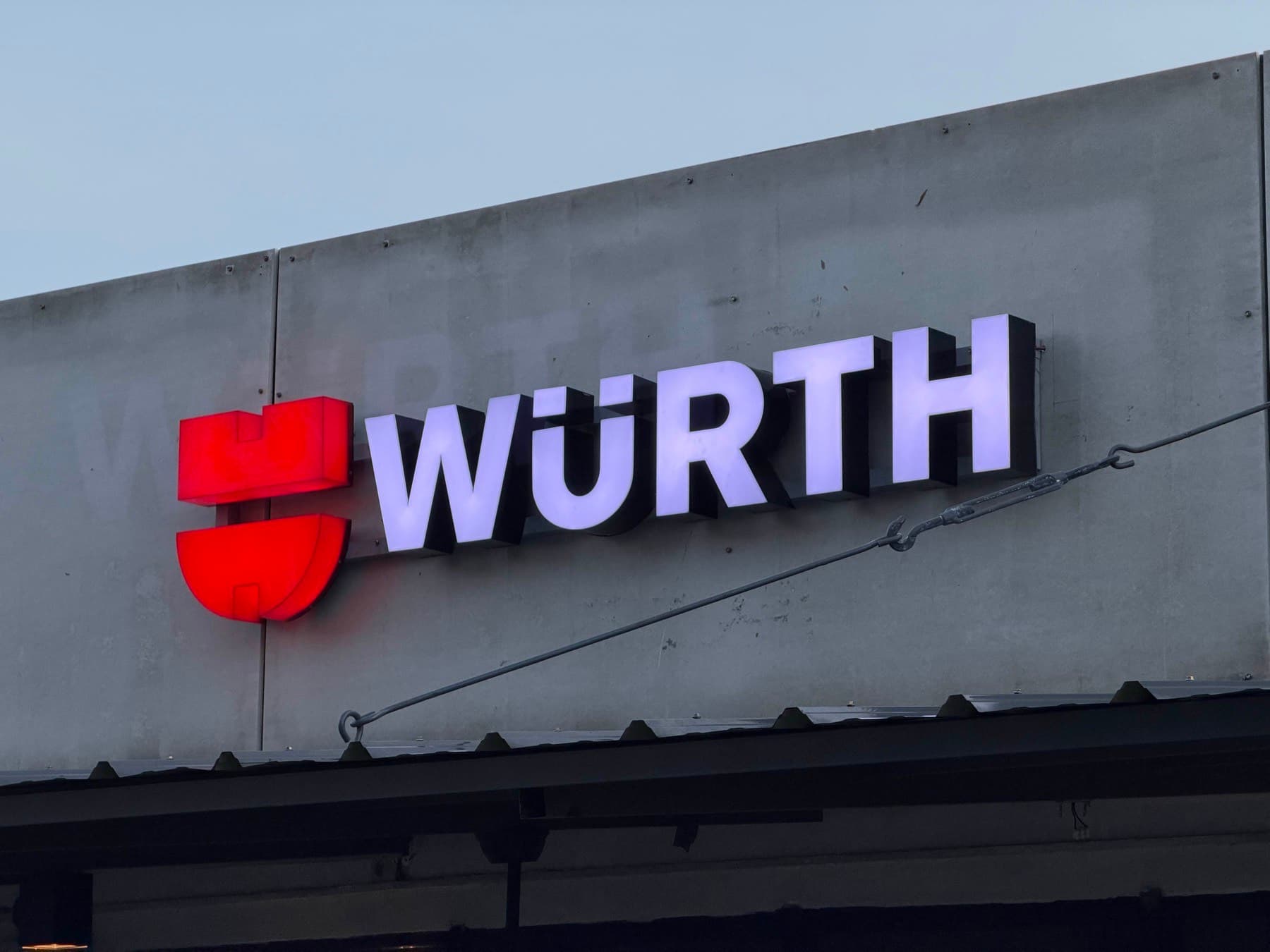 Illuminated exterior sign installation at night